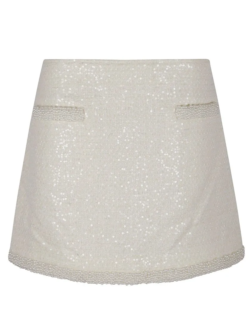Jupe mini en bouclé crème avec garniture perle